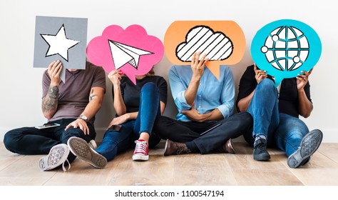 Diverse friends holding social media icons - Shutterstock ID 1100547194