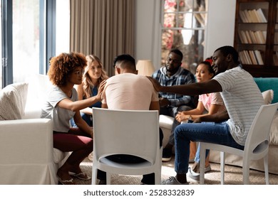 Diverse friends listening and comforting each other in group therapy session. Therapy, mental health, friendship and support, unaltered. - Powered by Shutterstock