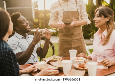 Diverse Friends Making Order In Outdoor Cafe