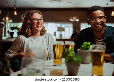 diverse friends out for dinner drinking beers  - Powered by Shutterstock