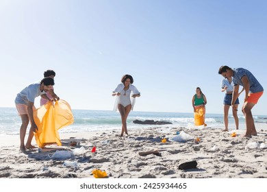 Diverse friends, part of a group, clean up a littered beach, collecting trash. These volunteers show environmental responsibility during a coastal cleanup. - Powered by Shutterstock