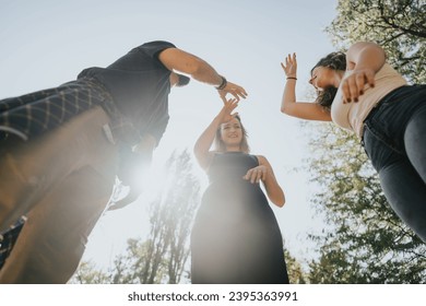 Diverse friends in a sunny city park enjoying nature, socializing, and having carefree conversations. Their positive energy radiates as they relax and embrace the freedom of the weekend. - Shutterstock ID 2395363991
