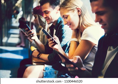Diverse friends using their phones - Shutterstock ID 1100446520