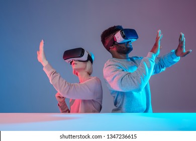 diverse funny friends enjoying VR technology, gadget concept, close up photo, isolated blue background - Powered by Shutterstock