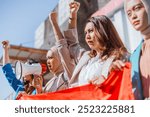 A diverse group of activists raising their fists and colorful banners during a protest