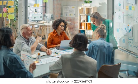 Diverse Group Adult Learners Listening to a Presentation from Female Renown Educator in Office Meeting Class Room. Business Coach Leads e-Commerce Courses, Educating Mature Students, Uses Whiteboard - Powered by Shutterstock