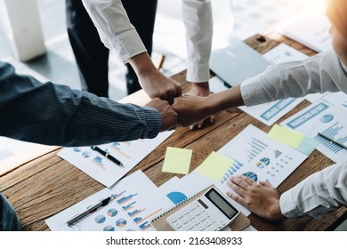 diverse group of asian business partner fist bump in modern office. Colleague partnership teamwork, university student, congratulation event, job or mission accomplish concept - Shutterstock ID 2163408933