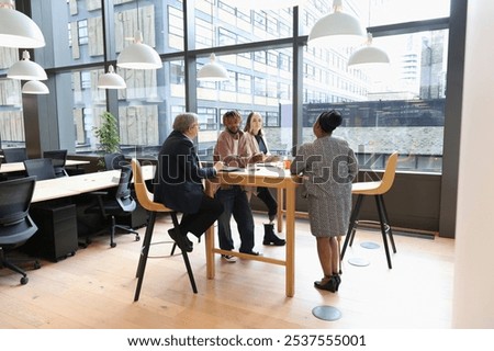 Similar – Group of young adults having business meeting in start up office