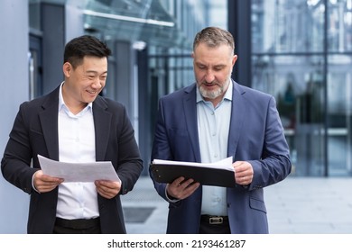 Diverse Group Of Business People, Men Talking And Discussing Plans, Colleagues Walking Outside Office Building, Workers In Business Suits