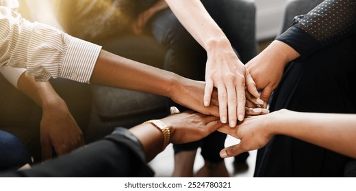 Diverse group of business people's hands showing unity and teamwork. Business people's hands of different ethnicity coming together in a display of teamwork and unity. Diverse hands for teamwork - Powered by Shutterstock