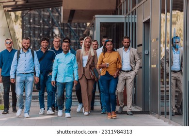 A diverse group of businessmen and colleagues walking together by their workplace, showcasing collaboration and teamwork in the company. - Shutterstock ID 2311984313