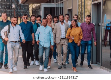 A diverse group of businessmen and colleagues walking together by their workplace, showcasing collaboration and teamwork in the company. - Shutterstock ID 2311984317