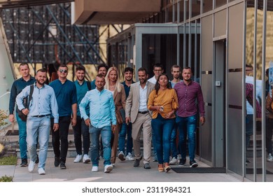 A diverse group of businessmen and colleagues walking together by their workplace, showcasing collaboration and teamwork in the company. - Shutterstock ID 2311984321