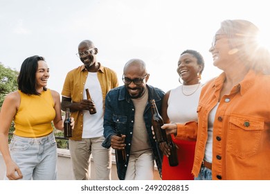 Diverse group of colleagues and friends bonding and laughing while enjoying drinks outdoors. Team-building and cheerful moment with beer and positive vibes. - Powered by Shutterstock