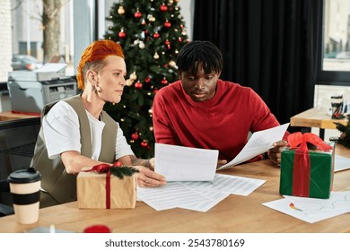 A diverse group of coworkers exchange gifts and enjoy the holiday spirit in an office. - Powered by Shutterstock