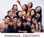 A diverse group of eleven young asian college students posing together looking happy. 6 women, 4 guys and 1 trans woman. Isolated on a white background.