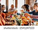 Diverse group enjoying a festive meal, toasting with wine. Celebrating together, sharing food, laughter, and joy. Festive atmosphere with friends and family. Celebrations and family gathering.