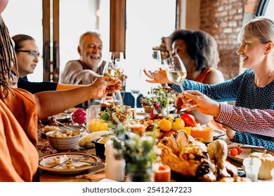 Diverse group enjoying a festive meal, toasting with wine. Celebrating together, sharing food, laughter, and joy. Festive atmosphere with friends and family. Celebrations and family gathering. - Powered by Shutterstock