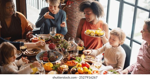 Diverse group of family and friends celebrate festive meal at restaurant. Diverse people family share food, festive thanksgiving meal at restaurant, autumn vibes, thanksgiving family dinner party - Powered by Shutterstock