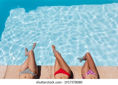 Diverse group of female friends sunbathing by pool on a sunny day. Hanging out and relaxing outdoors in summer. - Powered by Shutterstock