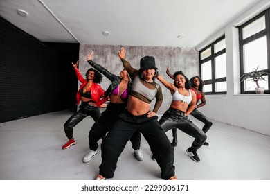 A diverse group of female hip hop dancers are in the studio practicing for an upcoming performance. - Powered by Shutterstock