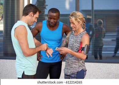 Diverse group of friends looking at their wearable technology that tracks theirs activity workout steps running statistics - Powered by Shutterstock