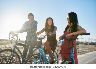 Diverse Group Of Friends On Bikes Stopping To Talk