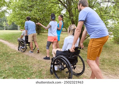 A diverse group of friends in a park, two using wheelchairs, actively participating in discussion with standing individuals on a sunny day. - Powered by Shutterstock