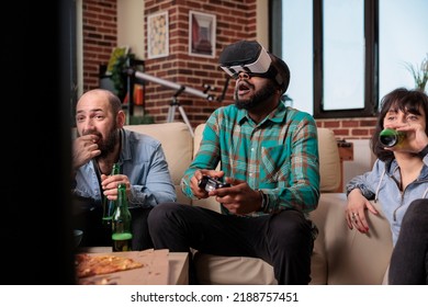 Diverse Group Of Friends Using Virtual Reality Headset To Play Video Games On Television. Having Fun With Beer Bottles And Snacks At House Party, Playing Competition With Vr Goggles.