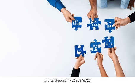 A diverse group of hands engaging in assembling blue puzzle pieces, symbolizing collaboration and teamwork in achieving business goals and innovative solutions. Amity