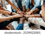 Diverse group of hands joined together, representing teamwork and unity. Symbolizes cooperation, collaboration, and the power of collective effort.