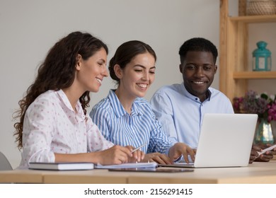 Diverse Group Of Happy Interns And Mentor Talking At Laptop Computer, Discussing New Professional Skills, Watching Online Learning Presentation, Smiling, Laughing. Business Education, Internship