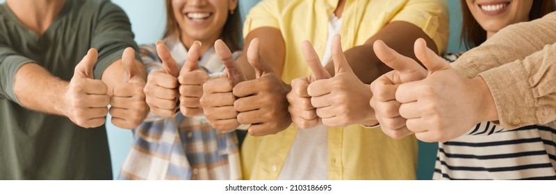 Diverse group of happy people giving thumbs up. Cheerful optimistic multiethnic multicultural men and women showing positive thumbs up gestures together. Human hands, close up, cropped shot, banner - Powered by Shutterstock