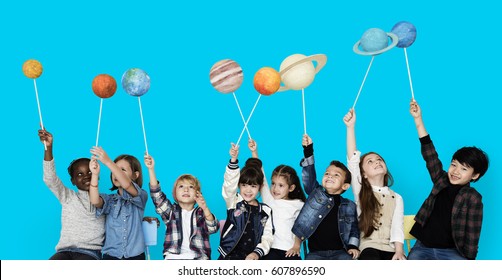 Diverse Group Of Kids Holding Planets On Sticks Isolated Background