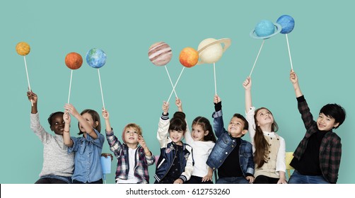 Diverse Group Of Kids Holding Planets On Sticks Isolated Background