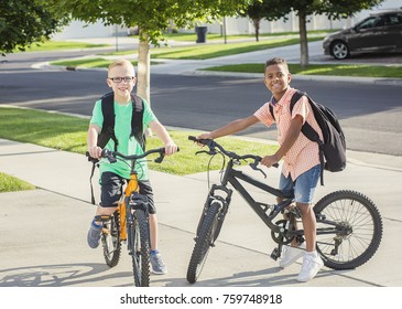 Diverse Group Of Kids Riding Their Bikes To School Together