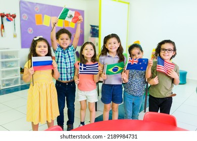 Diverse Group Of Kindergarten Children Holding Their Country Flags While Learning Geography And Different Cultures In Preschool