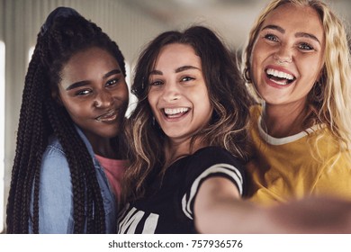 Diverse group of laughing young girlfriends taking a selfie together while enjoying a night out together - Shutterstock ID 757936576