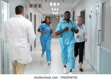 Diverse group of male and female doctors running through busy hospital corridor. medicine, health and healthcare services. - Powered by Shutterstock