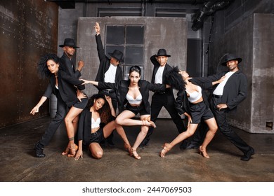 Diverse group of multiethnic dancers or performers showcase talent on stage in a contemporary dance show, dressed in black costumes. - Powered by Shutterstock