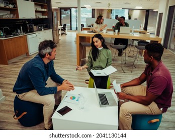 Diverse group of partners gather together to discuss paper work before meeting with boss and clients - Powered by Shutterstock