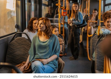 A diverse group of passengers, including women and a child, sitting and standing on a city bus during a sunny commute. - Powered by Shutterstock