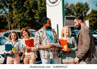 Diverse Group Of People On Work Break Outside At Business Area. Coworkers Have Discussion On Coffee Break. Multiethnic Colleagues In Casual Talk