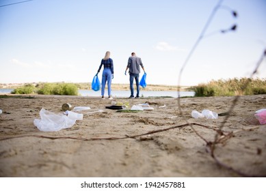 Diverse Group Of People Picking Up Trash In The Park Volunteer Community Service.