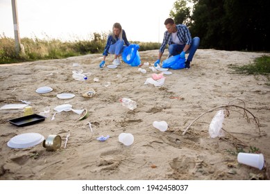 Diverse Group Of People Picking Up Trash In The Park Volunteer Community Service.