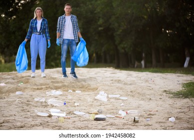 Diverse Group Of People Picking Up Trash In The Park Volunteer Community Service.