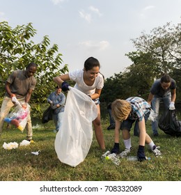 Diverse Group Of People Picking Up Trash In The Park Volunteer Community Service