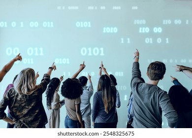 Diverse group of people pointing at a screen with binary code. The diverse group of people pointing at the digital binary code display. Digital computing, technology background with copy space. - Powered by Shutterstock - Get 15% off with code: PIKWIZARD15