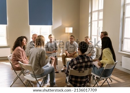 Diverse group of people sat in circle for a Therapy recovery meeting