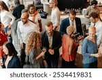 Diverse group of people at social event, mingling and chatting. Diverse crowd enjoy drinks and conversation in lively social gathering party. Social event with diverse group of people mingling